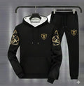 Men's black royal crest hoodie track suit with gold floral sleeves - front view